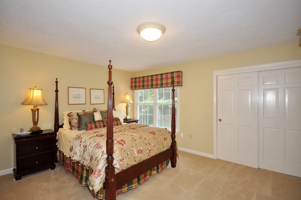 54 Phillips Road Sudbury, MA 01776 - Photo 20 of 30 a bedroom with a bed and a lamp