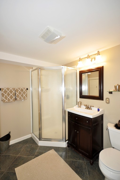 54 Phillips Road Sudbury, MA 01776 - Photo 25 of 30 a bathroom with a sink mirror toilet and vanity
