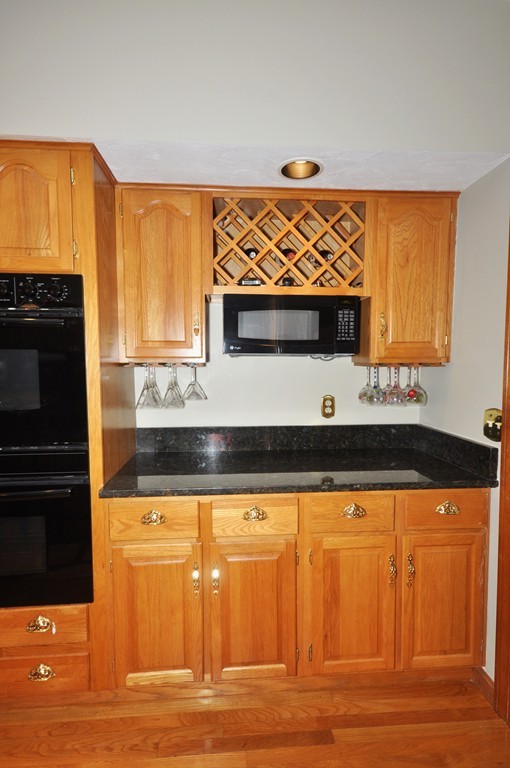 54 Phillips Road Sudbury, MA 01776 - Photo 6 of 30 a kitchen with stainless steel appliances granite countertop a stove and a microwave