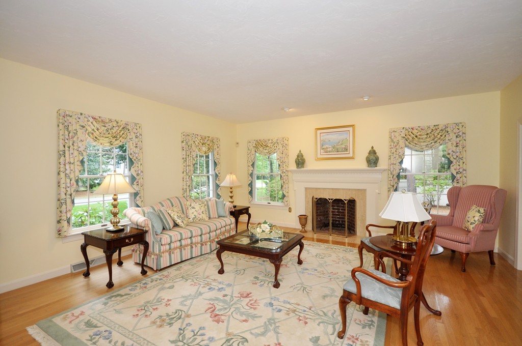 54 Phillips Road Sudbury, MA 01776 - Photo 10 of 30 a living room with furniture a fireplace and a table