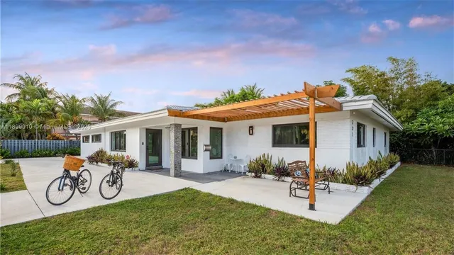a view of a house with patio furniture and a porch