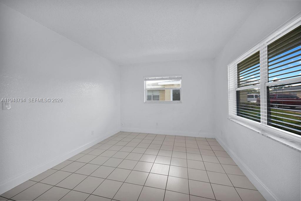 642 Kathy Court Margate, FL 33068 - Photo 23 of 45 a view of an empty room with a window