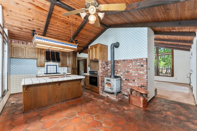 a kitchen that has a stove and a table