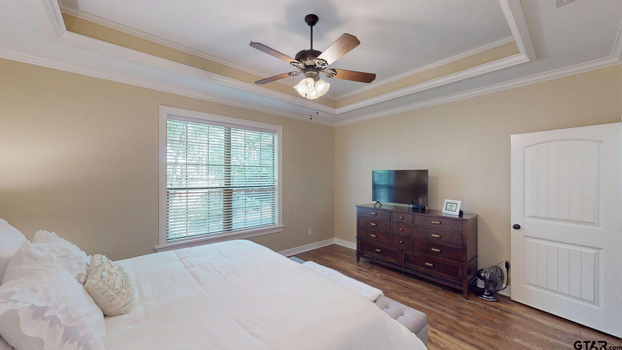 18488 Bluebird Circle Flint, TX 75762 - Photo 20 of 47 a bedroom with a bed and a flat tv screen on dresser