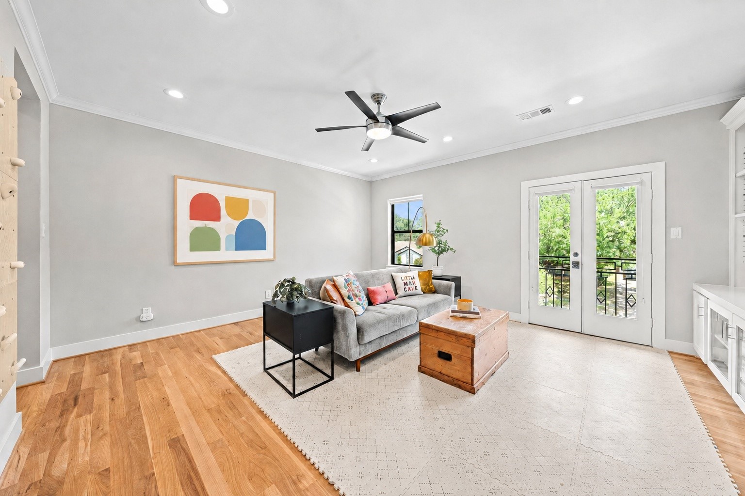 1013 Martin Street Houston, TX 77018 - Photo 28 of 46 Another view of this light-filled game room featuring French doors opening to a front balcony, built-in cabinetry, ceiling fan, & plenty of space for lounging, play, or media use.