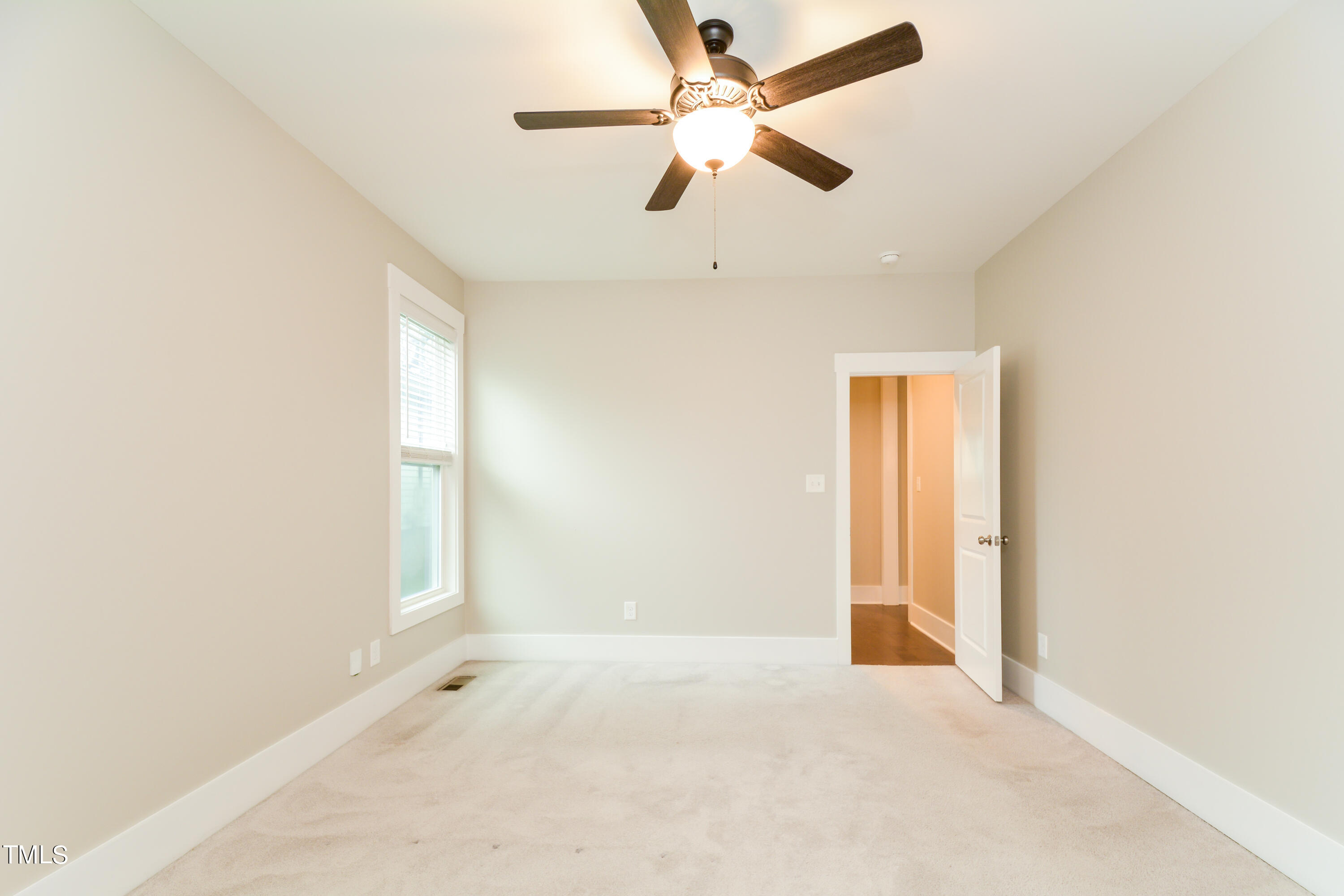 510 Eugene Street Durham, NC 27701 - Photo 12 of 15 an empty room with a window and a fan