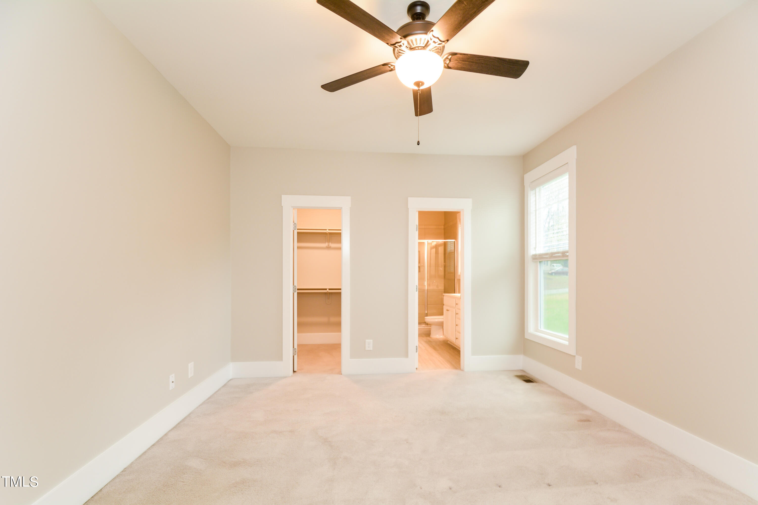 510 Eugene Street Durham, NC 27701 - Photo 13 of 15 an empty room with chandelier fan and windows