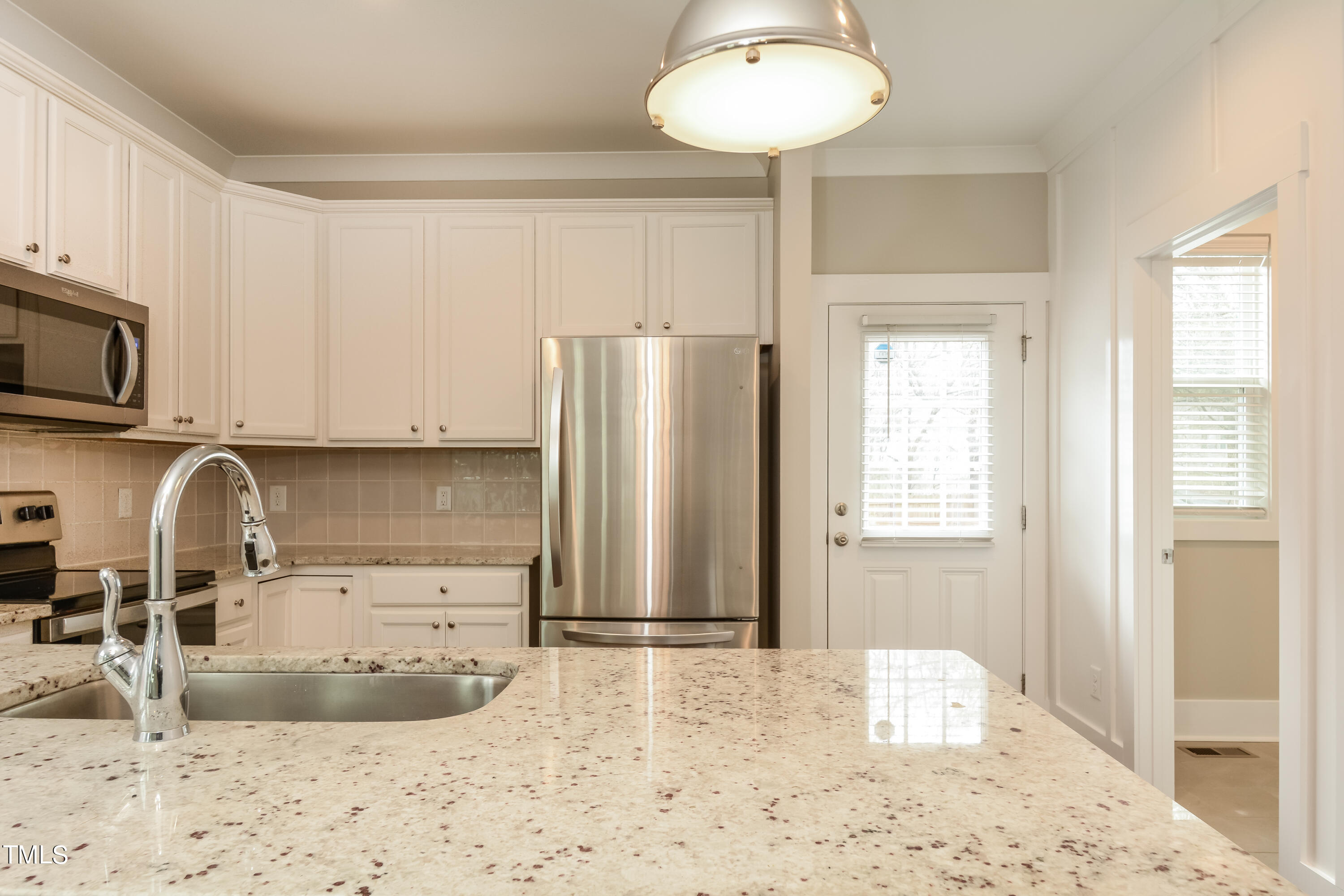 510 Eugene Street Durham, NC 27701 - Photo 3 of 15 a kitchen with stainless steel appliances granite countertop a sink refrigerator and cabinets