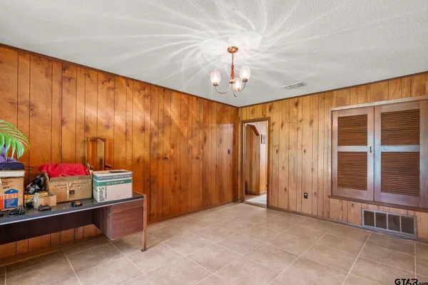 a bedroom with a bed and a chandelier