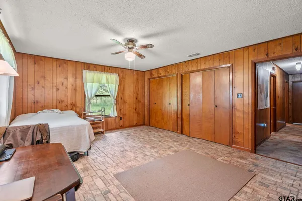 a bedroom with a bed and large window