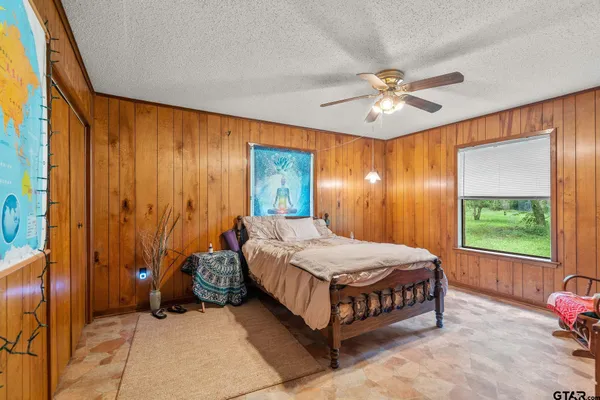 a bedroom with a bed and a window