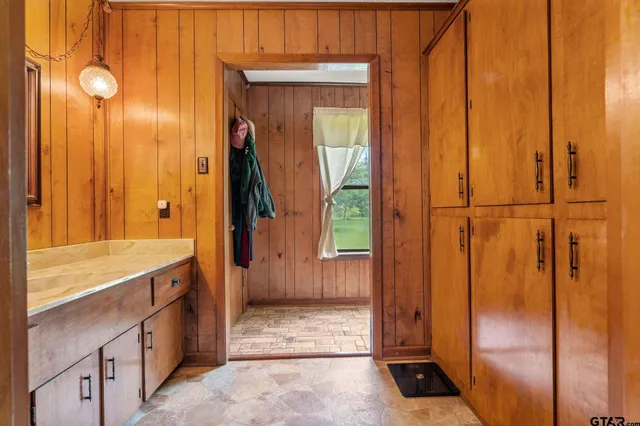 a bathroom with a granite countertop toilet sink and mirror