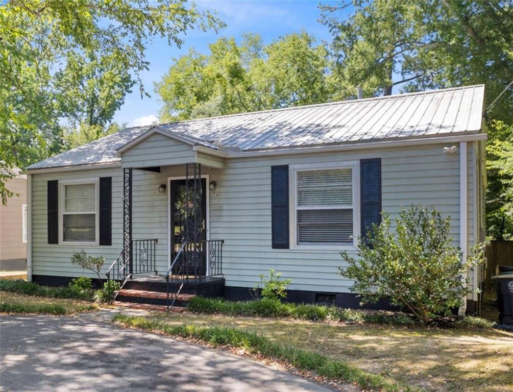 721 Charlton Street Northwest Rome, GA 30165 - Photo 1 of 1 a view of a house with a yard plants and large tree