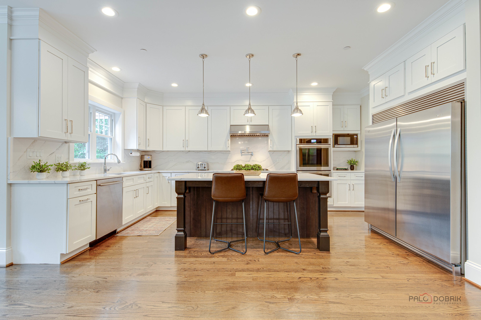 192 Gage Road Riverside, IL 60546 - Photo 12 of 56 a kitchen with stainless steel appliances kitchen island granite countertop a refrigerator a stove a sink a dining table and chairs