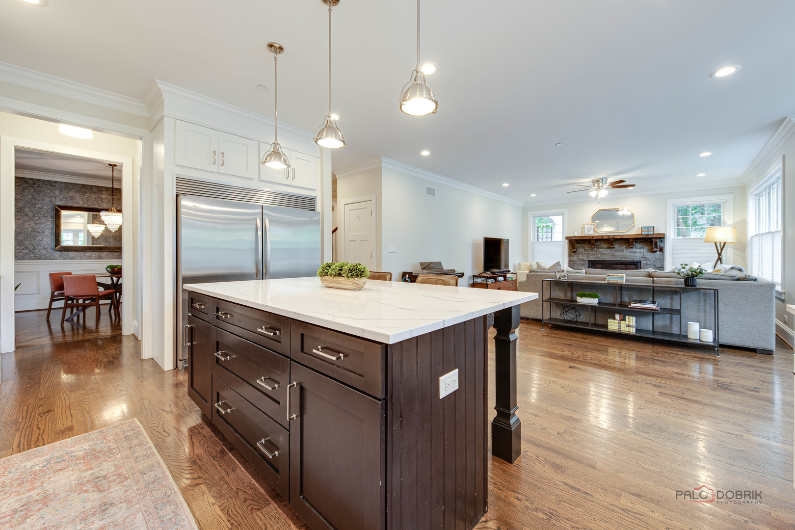 192 Gage Road Riverside, IL 60546 - Photo 17 of 56 a kitchen with a stove kitchen island and couches with wooden floor
