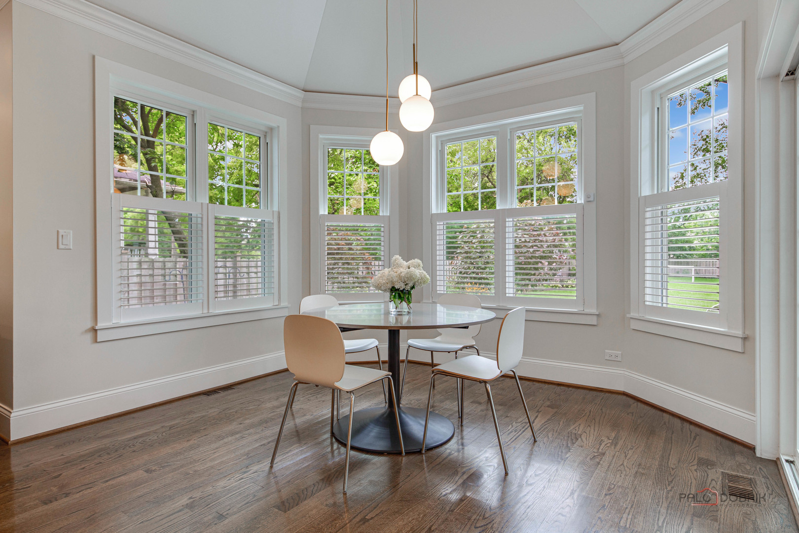 192 Gage Road Riverside, IL 60546 - Photo 18 of 56 a dining room with wooden floor a chandelier a glass table and chairs