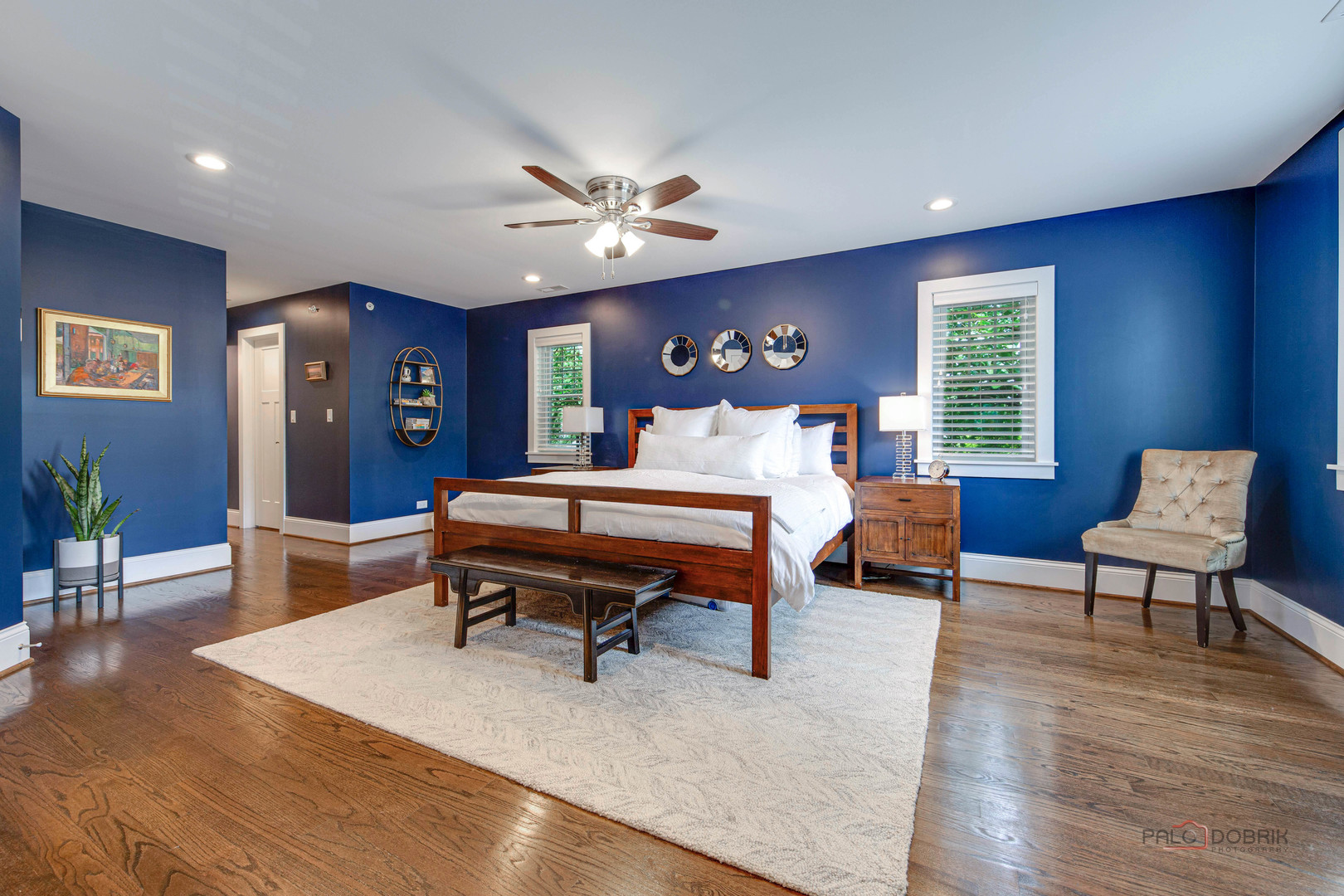 192 Gage Road Riverside, IL 60546 - Photo 24 of 56 a living room with furniture a dining table and paintings on the wall with wooden floor