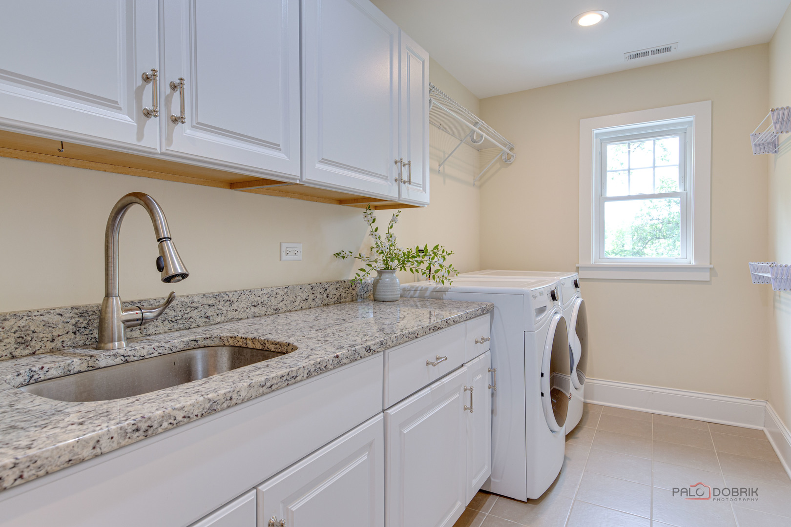 192 Gage Road Riverside, IL 60546 - Photo 39 of 56 a kitchen with stainless steel appliances granite countertop a sink a window and cabinets
