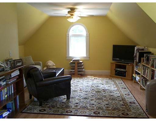 52 Hardy Road, Unit 77 Bedford, NH 03110 - Photo 12 of 15 a living room with furniture and a flat screen tv