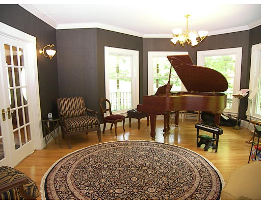 52 Hardy Road, Unit 77 Bedford, NH 03110 - Photo 3 of 15 a living room with furniture and a chandelier