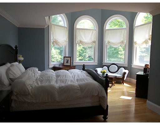 52 Hardy Road, Unit 77 Bedford, NH 03110 - Photo 8 of 15 a bed sitting in a bedroom next to a large window