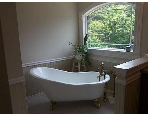 52 Hardy Road, Unit 77 Bedford, NH 03110 - Photo 9 of 15 a bathroom with a bathtub and window