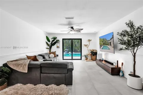 a living room with furniture potted plant and a window