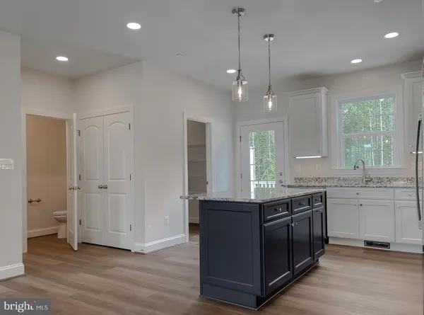 a kitchen with granite countertop a stove and a sink