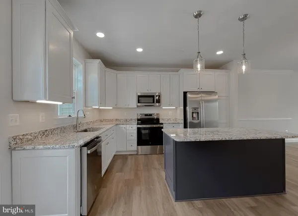 a kitchen with a sink stainless steel appliances and cabinets