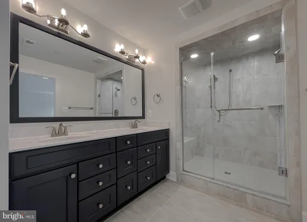 a bathroom with a shower sink double and mirror