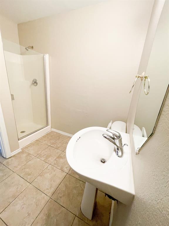 2704 Clemson Circle, Unit A Rowlett, TX 75088 - Photo 5 of 13 a bathroom with a sink and shower