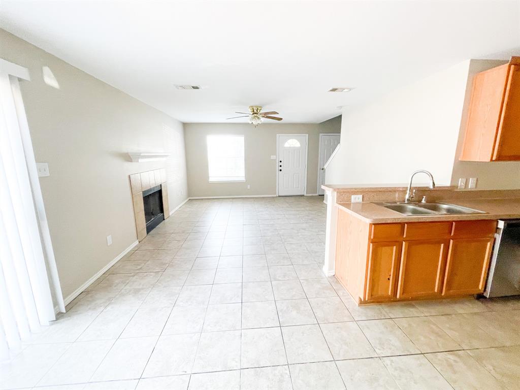 2704 Clemson Circle, Unit A Rowlett, TX 75088 - Photo 8 of 13 a view of a kitchen with a sink dishwasher and a fireplace