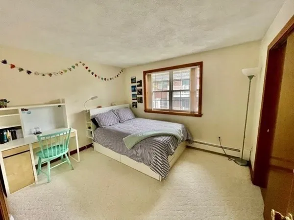 a spacious bedroom with a bed and a window