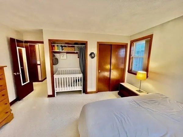 a bedroom with a bed and a mirror