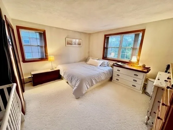 a spacious bedroom with a bed and a window