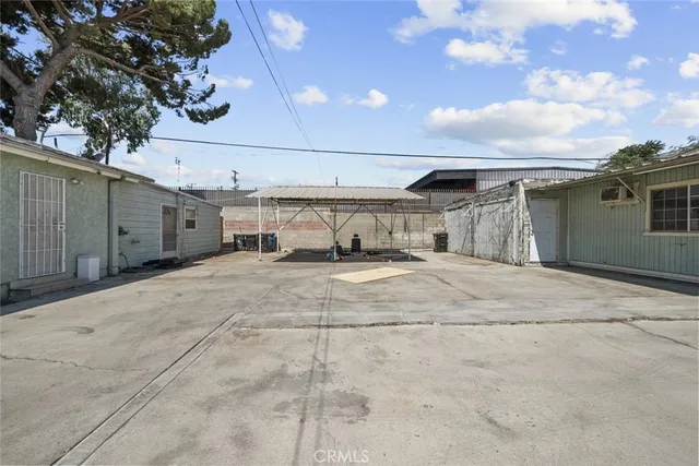 a view of a parking space with potted plants