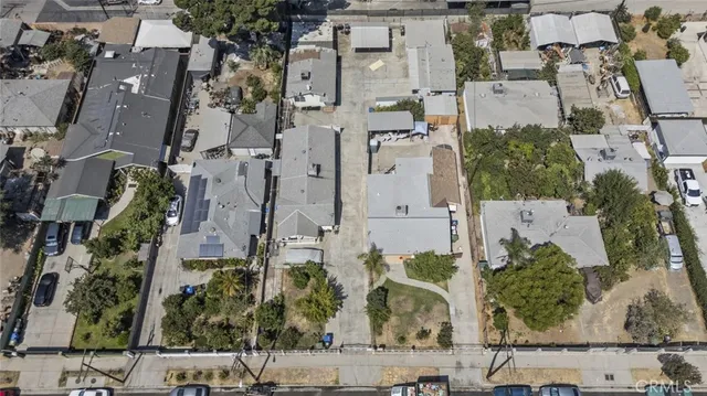 an aerial view of residential houses with outdoor space