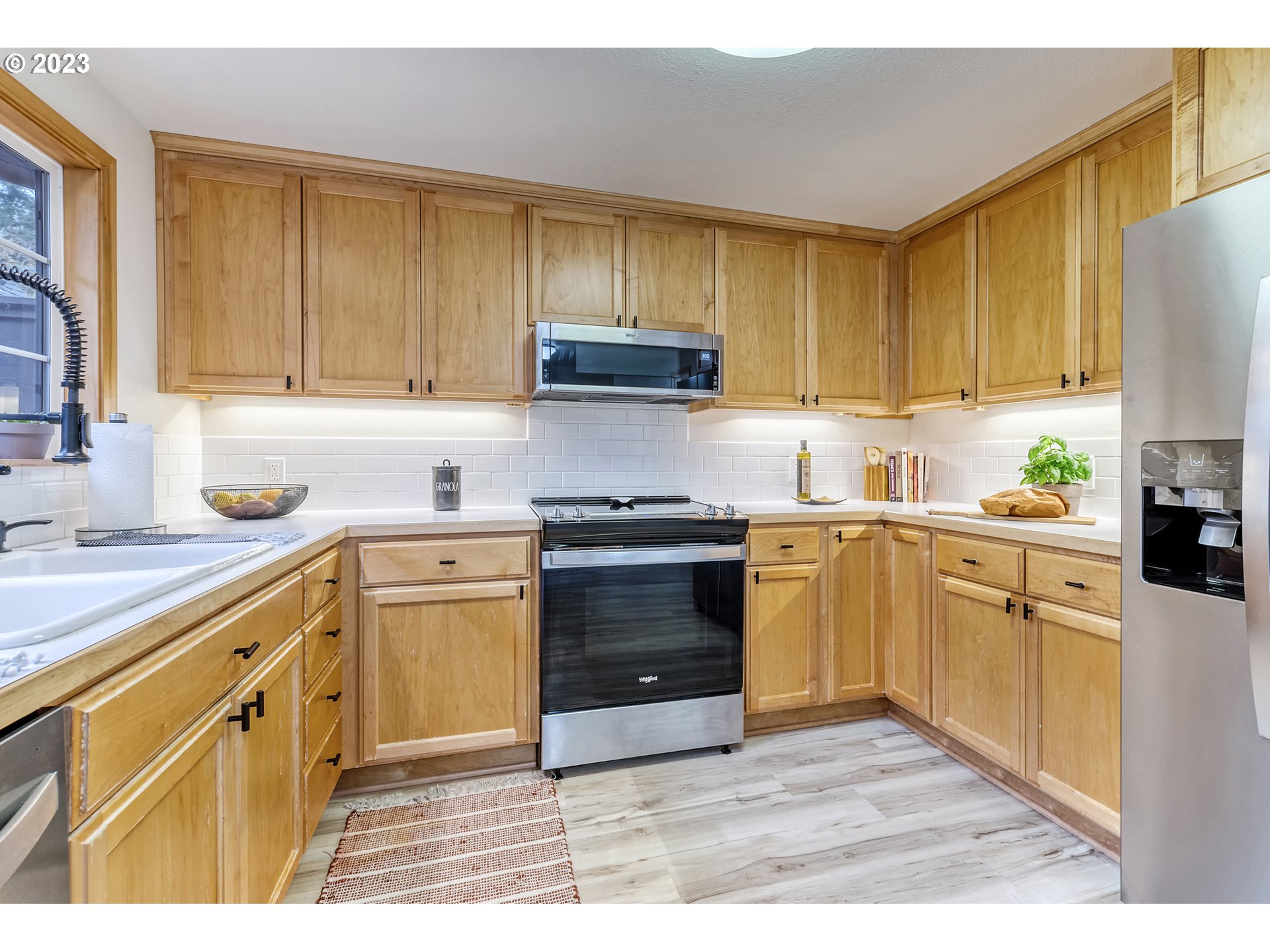 109 Westbrook Way Eugene, OR 97405 - Photo 11 of 36 a kitchen with granite countertop wooden cabinets and a stove top oven