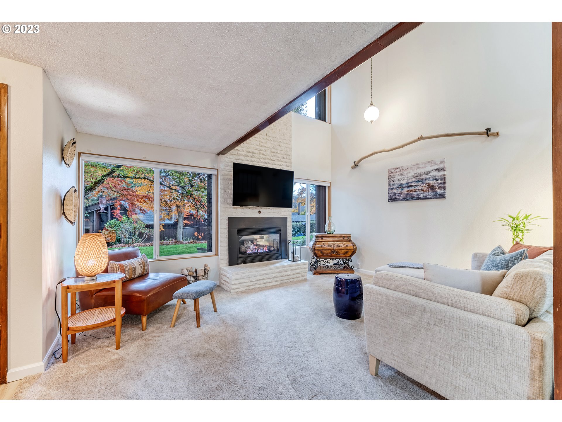 109 Westbrook Way Eugene, OR 97405 - Photo 7 of 36 a living room with furniture a flat screen tv and a fireplace