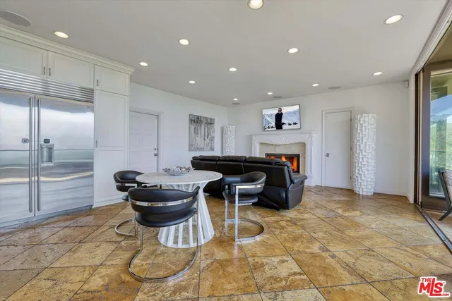 a large kitchen with kitchen island a large counter top stainless steel appliances and cabinets