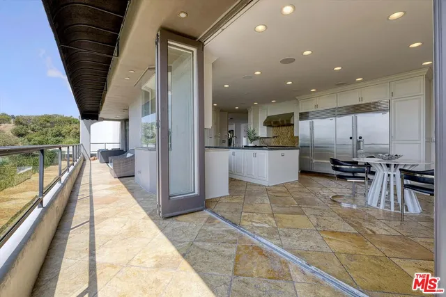 a large kitchen with granite countertop a stove and a sink