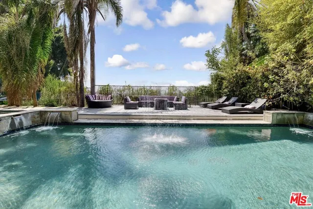 a view of a swimming pool with outdoor seating and lake