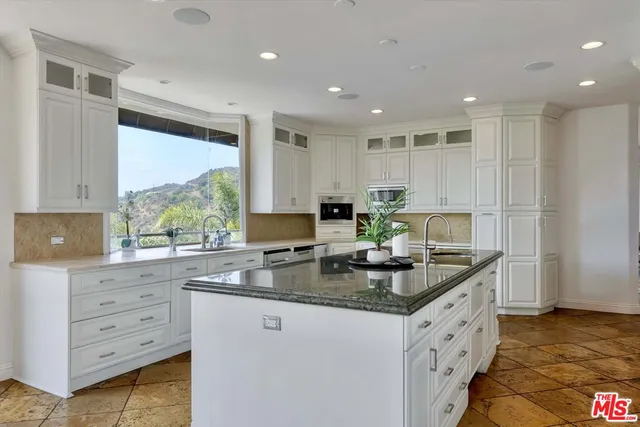 a room with furniture pool table and windows