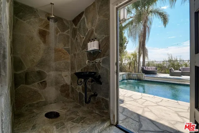 a spacious bathroom with a bathtub sink and mirror