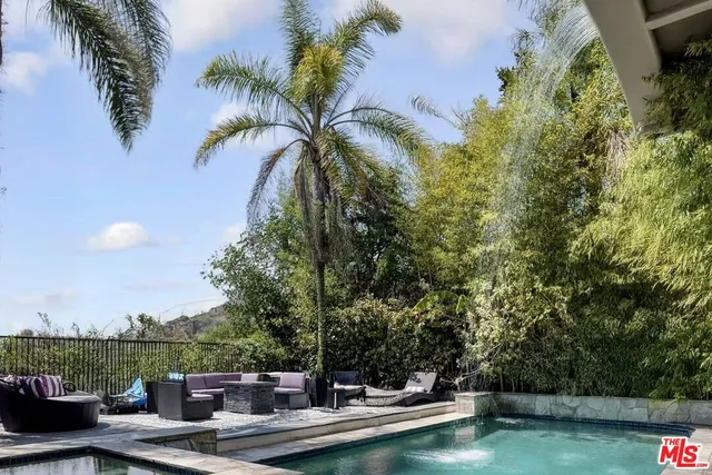 a view of a swimming pool with a table and chairs
