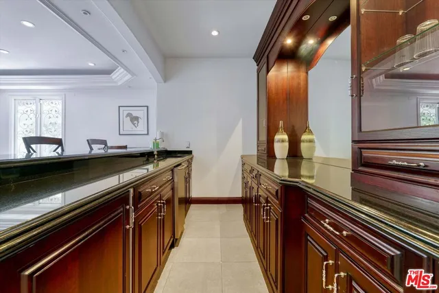 a bed sitting in a spacious bedroom next to a window and a larger closet