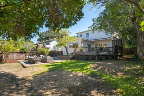 a view of a house with backyard porch and sitting area