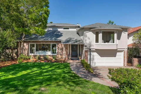 a front view of a house with a garden and porch