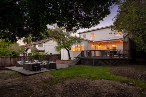 a view of a couches and table in backyard of the house