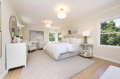 a bed room with a bed and a large window